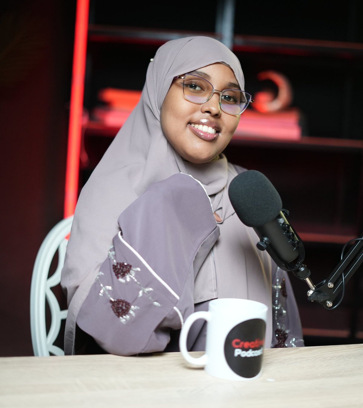 Lula Abdulkadir Issa at the microphone in the Creative Podcast studio